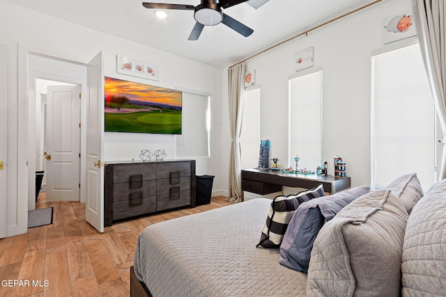 bedroom with light wood-style flooring and a ceiling fan