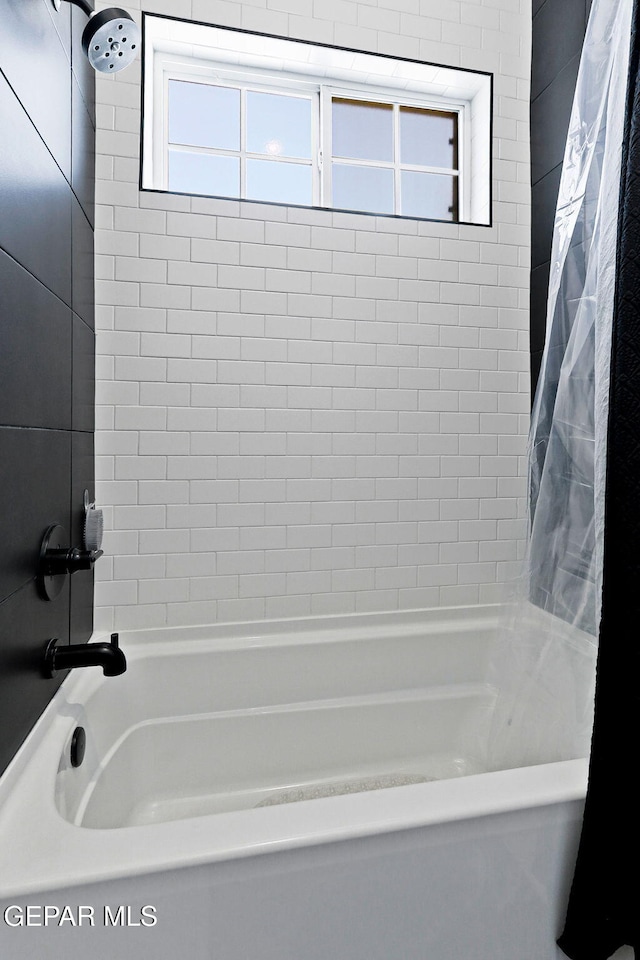 full bath featuring shower / tub combo and a wealth of natural light