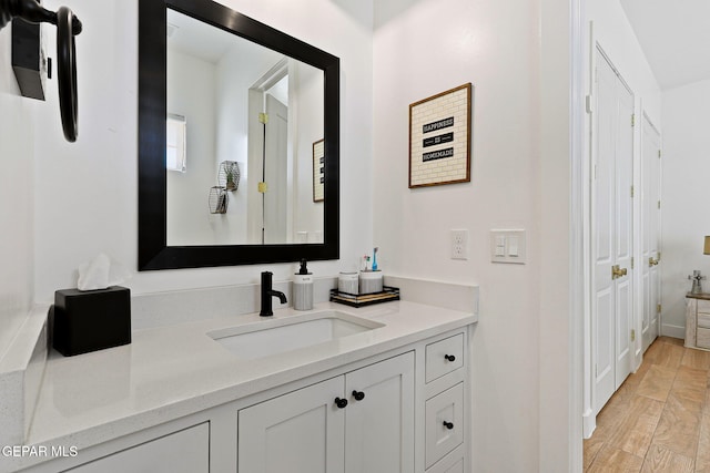 bathroom with vanity and wood finished floors