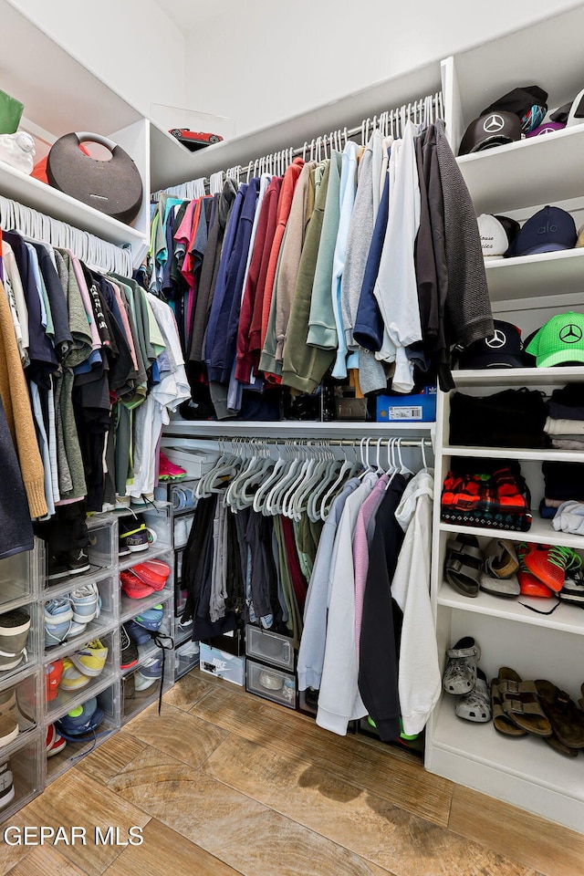 spacious closet with wood finished floors