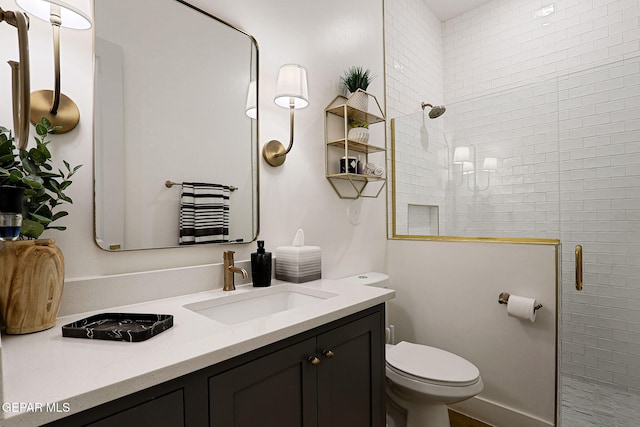 full bath featuring vanity, a shower stall, and toilet