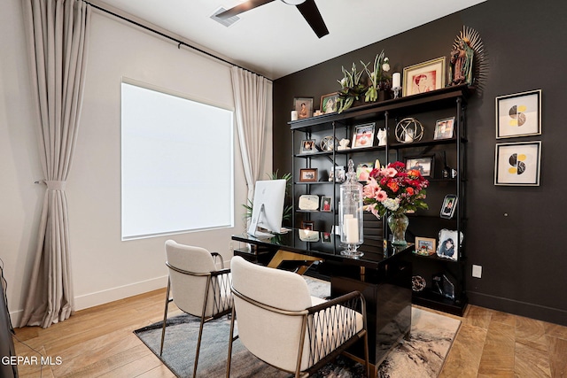 office featuring visible vents, baseboards, ceiling fan, and wood finished floors