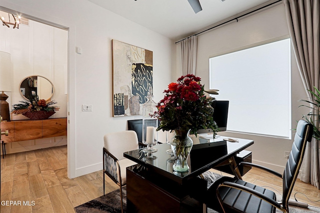 dining area with light wood-type flooring and baseboards