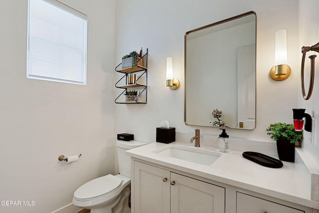 bathroom with toilet and vanity