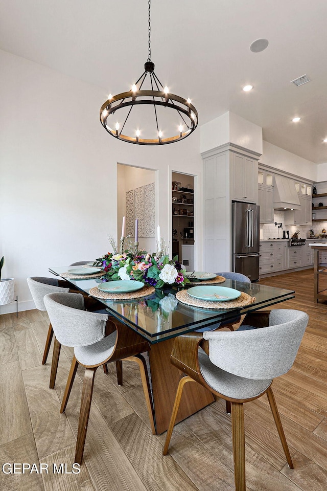 dining area featuring light wood-style flooring, recessed lighting, and visible vents