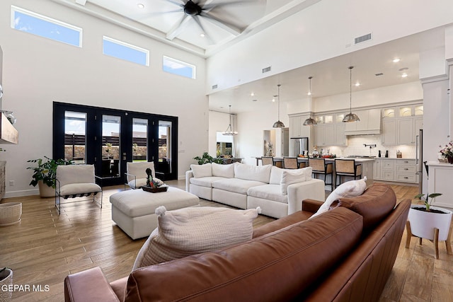 living room featuring visible vents, recessed lighting, baseboards, and wood-type flooring