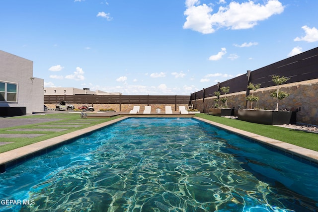 view of swimming pool featuring a fenced in pool and a fenced backyard