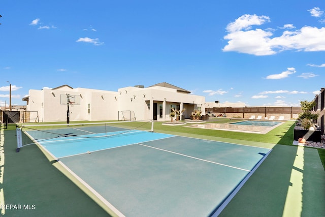 view of tennis court featuring fence