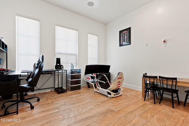 home office featuring baseboards and wood finished floors