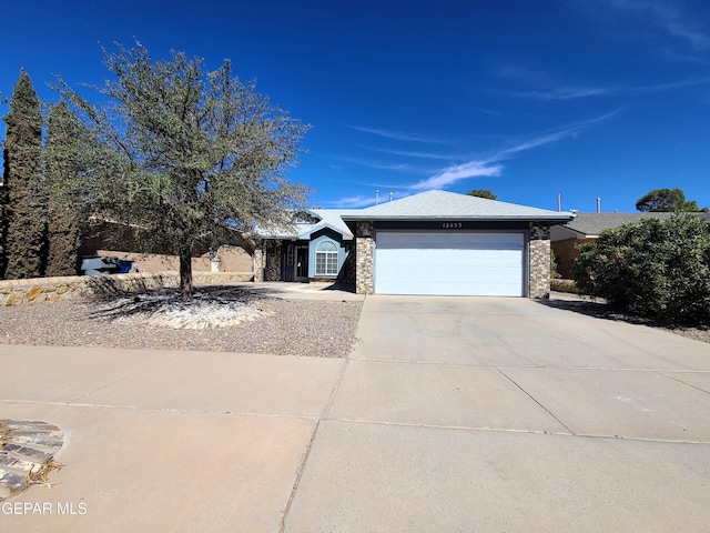 view of front facade featuring brick siding, an attached garage, and driveway