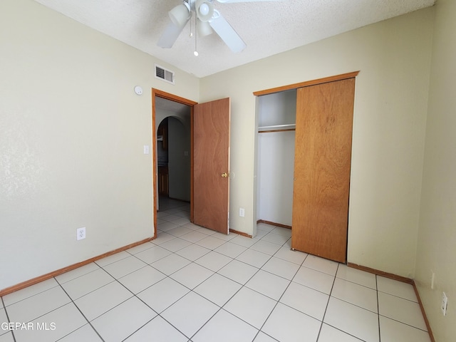 unfurnished bedroom with visible vents, ceiling fan, baseboards, a closet, and a textured ceiling