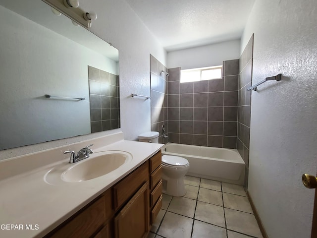 bathroom featuring vanity, tile patterned flooring, shower / bath combination, toilet, and a textured wall