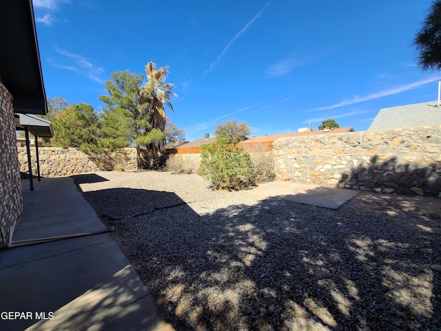 view of yard with a patio area and a fenced backyard