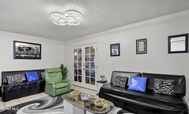 living room featuring tile patterned flooring, french doors, and a textured ceiling