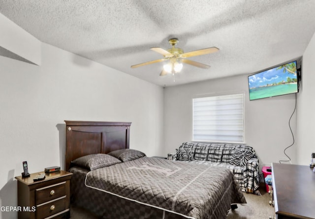 bedroom featuring a textured ceiling, carpet, and a ceiling fan