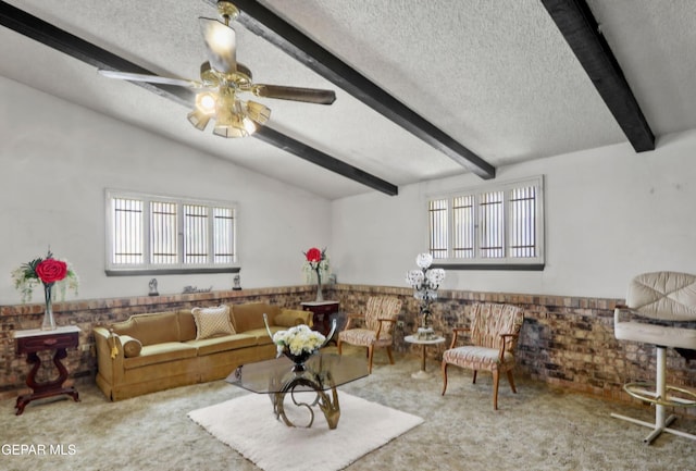 carpeted living room featuring a ceiling fan, a wainscoted wall, a textured ceiling, and lofted ceiling with beams