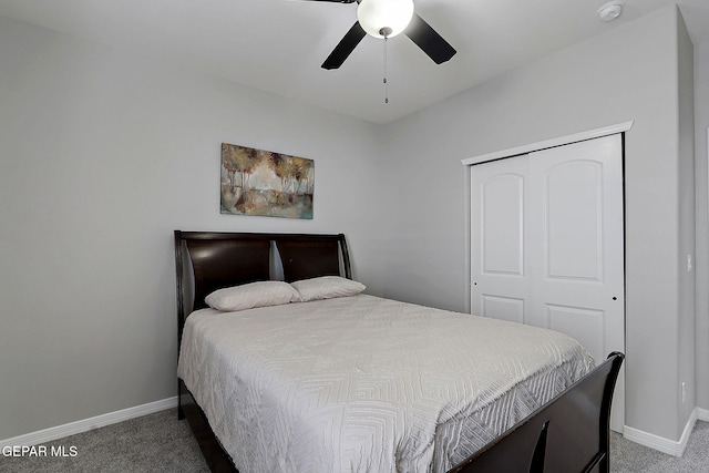 carpeted bedroom featuring baseboards, a closet, and ceiling fan