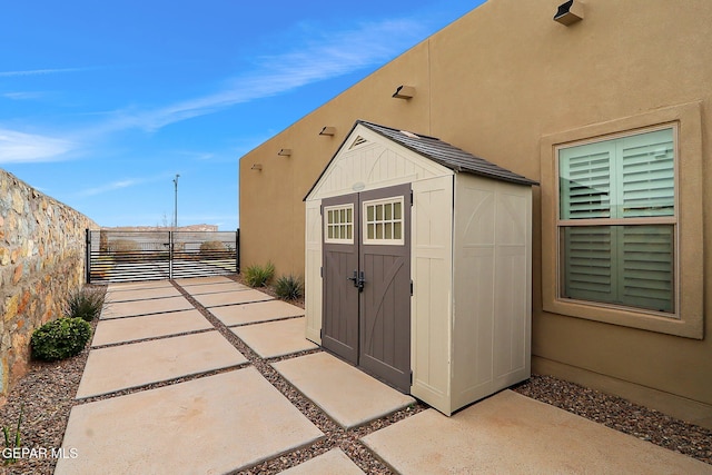 view of shed featuring fence