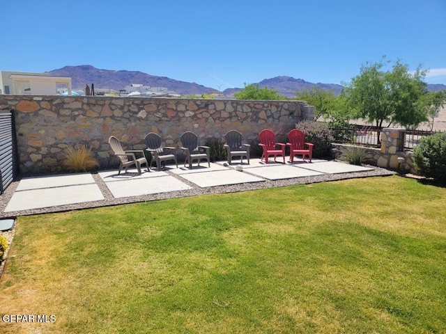 view of yard with a mountain view, a patio, and fence