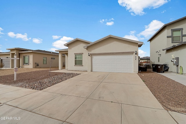 view of front of home featuring a garage, driveway, and stucco siding