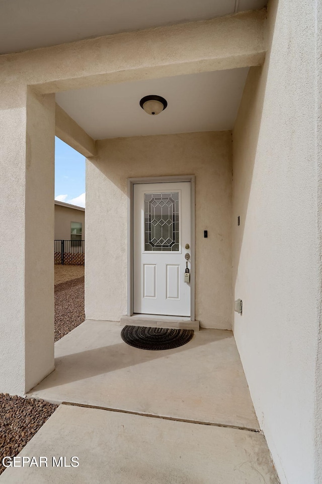 property entrance featuring stucco siding