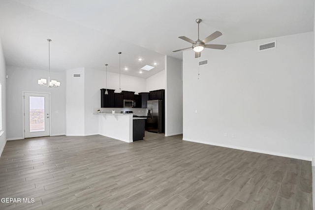 kitchen featuring a breakfast bar, open floor plan, stainless steel appliances, and visible vents