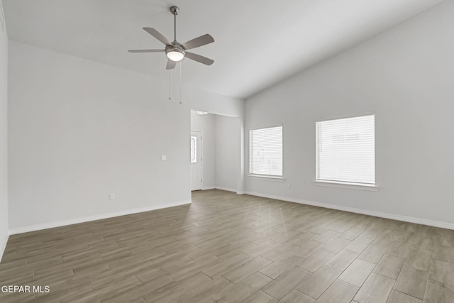 empty room with wood finished floors, baseboards, lofted ceiling, and ceiling fan