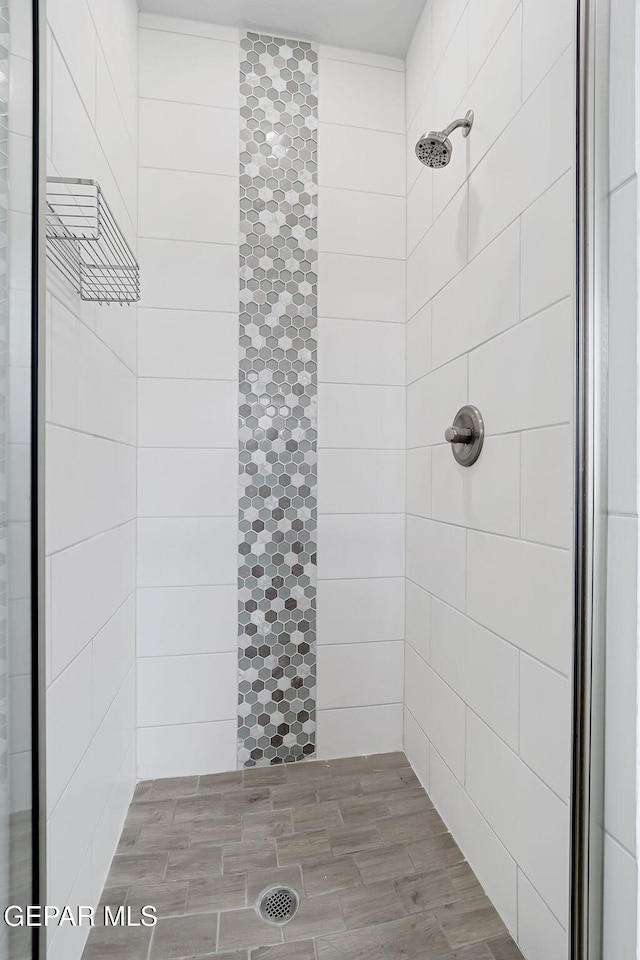 full bath with tiled shower