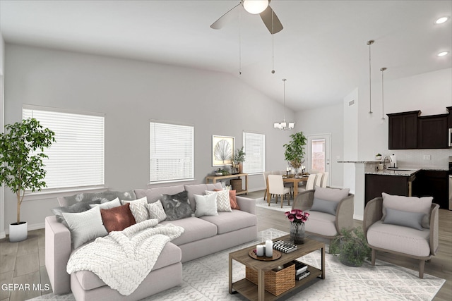 living area with recessed lighting, ceiling fan with notable chandelier, and high vaulted ceiling