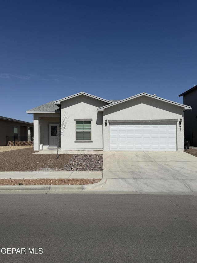 view of front facade with stucco siding, driveway, and an attached garage