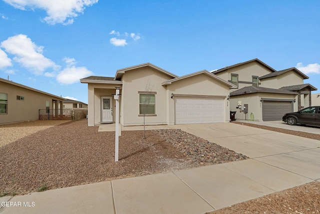 ranch-style home with stucco siding, a garage, driveway, and fence