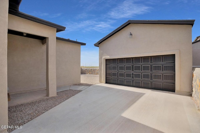 garage with concrete driveway
