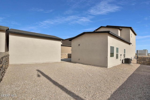 view of side of home featuring stucco siding and central air condition unit