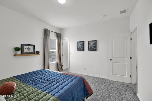 carpeted bedroom featuring baseboards