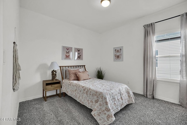 bedroom with baseboards and carpet floors