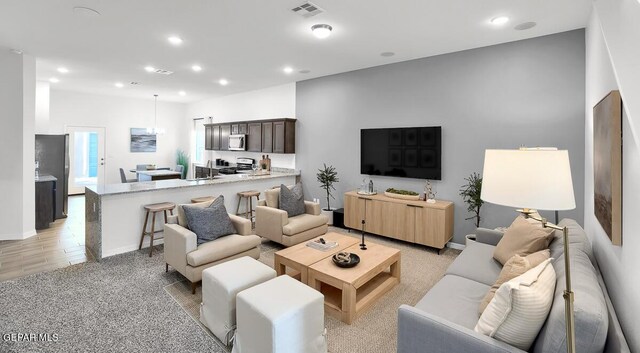 living area with recessed lighting and baseboards