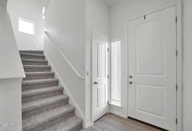 entryway with stairway and wood finished floors
