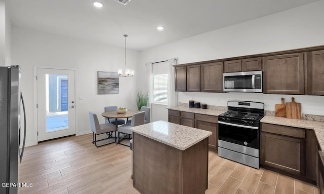 kitchen with appliances with stainless steel finishes, light wood-style flooring, dark brown cabinets, a chandelier, and recessed lighting