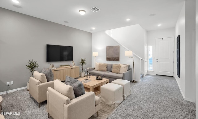 living area featuring light colored carpet, baseboards, stairs, and recessed lighting