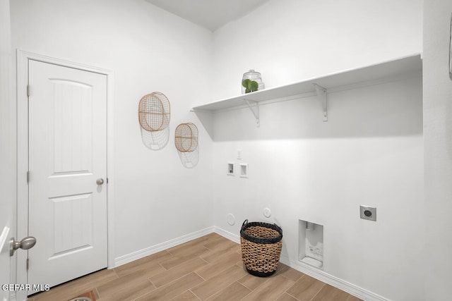 laundry room featuring gas dryer hookup, hookup for an electric dryer, light wood-style floors, hookup for a washing machine, and baseboards