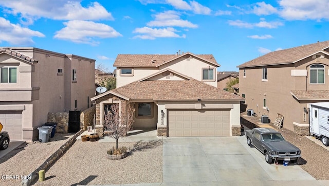 view of front of house featuring stucco siding, concrete driveway, and an attached garage