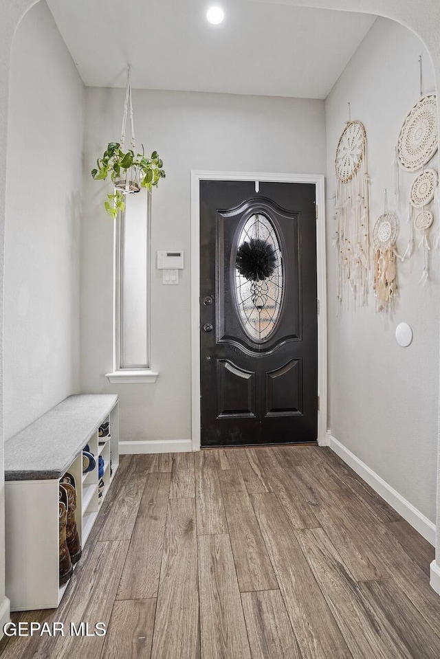 entryway featuring wood finished floors and baseboards