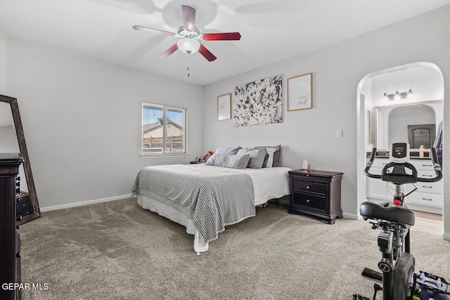 carpeted bedroom with ceiling fan and baseboards