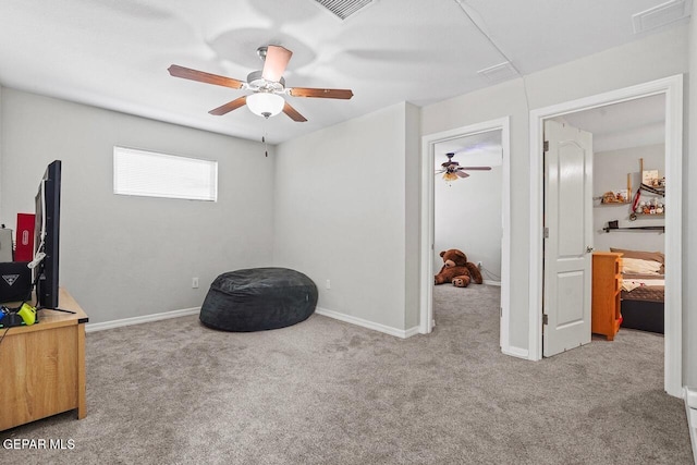 interior space featuring visible vents, carpet floors, baseboards, and a ceiling fan