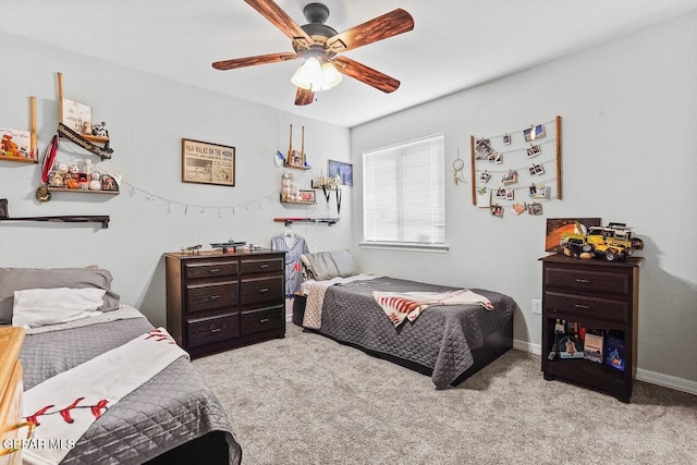 carpeted bedroom with baseboards and ceiling fan