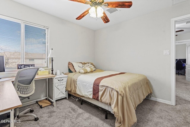 bedroom featuring light carpet, visible vents, a ceiling fan, and baseboards