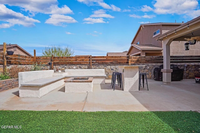 view of patio / terrace with outdoor dry bar, an outdoor kitchen, and fence