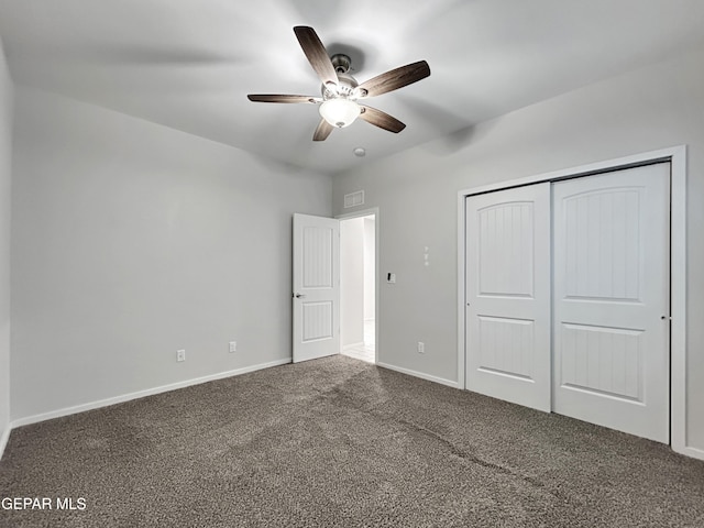 unfurnished bedroom featuring visible vents, a closet, carpet floors, baseboards, and ceiling fan