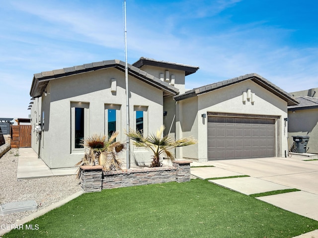 view of front of home featuring fence, driveway, stucco siding, a front lawn, and a garage