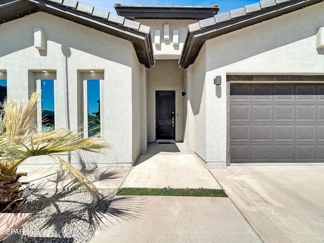 doorway to property featuring stucco siding